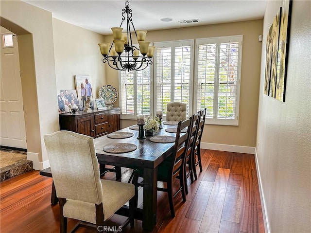 14207 Ashton Ln, Riverside, CA 92508 - dining room featuring arched walkways, healthy amount of natural light, dark wood-style floors, and a chandelier
