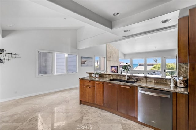 34586 Camino Capistrano Unit B, Dana Point, CA 92624 - kitchen featuring stainless steel dishwasher, vaulted ceiling, dark stone countertops, brown cabinets, and recessed lighting