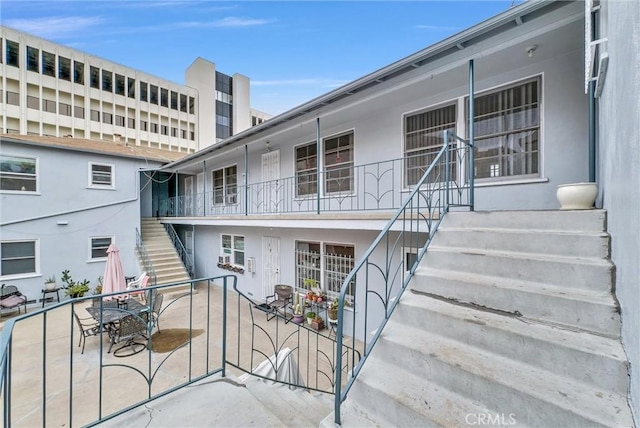 122 Elm Ave Unit 10, Long Beach, CA 90802 - exterior space with stairway, stucco siding, and outdoor dining space