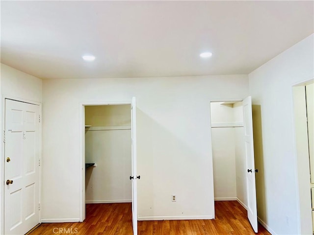 122 Elm Ave Unit 10, Long Beach, CA 90802 - unfurnished bedroom featuring a spacious closet, wood finished floors, recessed lighting, and a closet