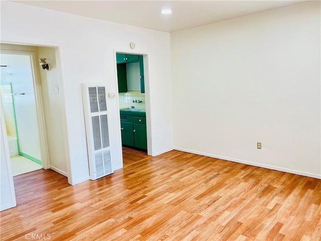 122 Elm Ave Unit 10, Long Beach, CA 90802 - spare room featuring a heating unit, light wood finished floors, and recessed lighting