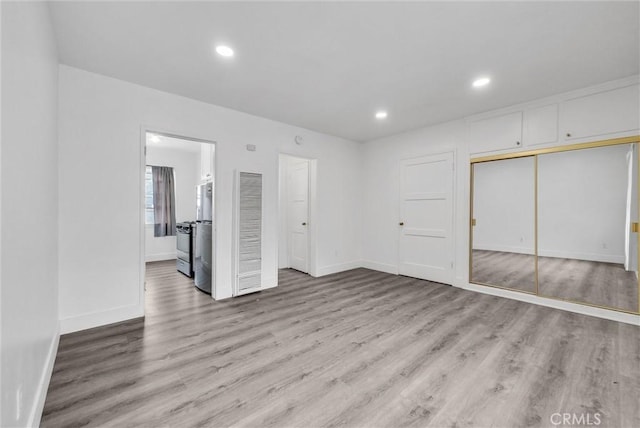 122 Elm Ave Unit 11, Long Beach, CA 90802 - unfurnished bedroom featuring wood finished floors, recessed lighting, a closet, and ensuite bathroom