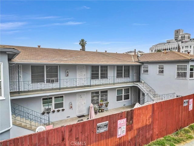 122 Elm Ave Unit 11, Long Beach, CA 90802 - view of front of home featuring stucco siding, roof with shingles, and cooling unit
