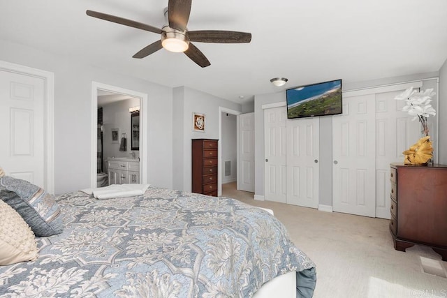 2203 Cameo Rd, Carlsbad, CA 92008 - bedroom featuring light colored carpet, two closets, connected bathroom, and ceiling fan