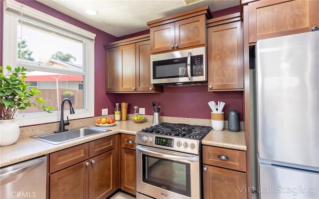 7441 Sylvia Ave, Reseda, CA 91335 - kitchen with stainless steel appliances, light countertops, and brown cabinetry