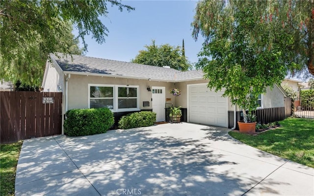 7441 Sylvia Ave, Reseda, CA 91335 - view of front of house featuring a garage, concrete driveway, stucco siding, and roof with shingles