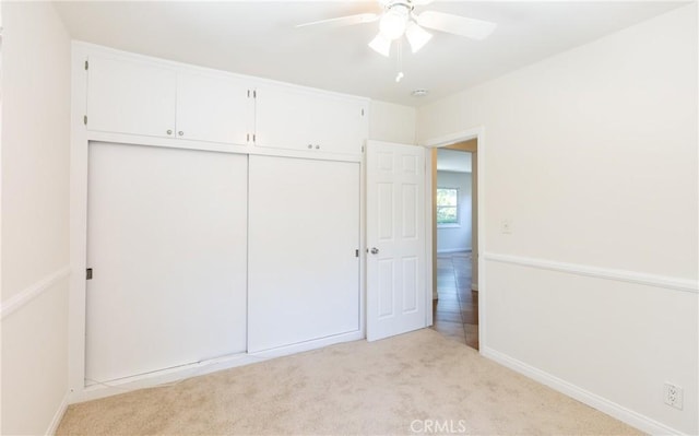 7441 Sylvia Ave, Reseda, CA 91335 - unfurnished bedroom with light colored carpet, a closet, and ceiling fan