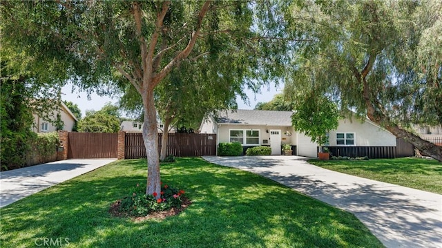 7441 Sylvia Ave, Reseda, CA 91335 - view of front of home with concrete driveway, an attached garage, and stucco siding