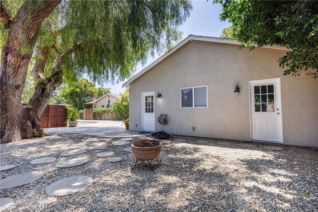 7441 Sylvia Ave, Reseda, CA 91335 - rear view of house featuring an outdoor fire pit, a patio, and stucco siding