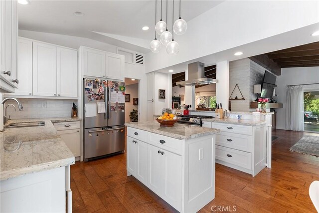 4835 Almidor Ave, Woodland Hills, CA 91364 - kitchen with stainless steel appliances, wall chimney range hood, wood-type flooring, light stone counters, and white cabinetry