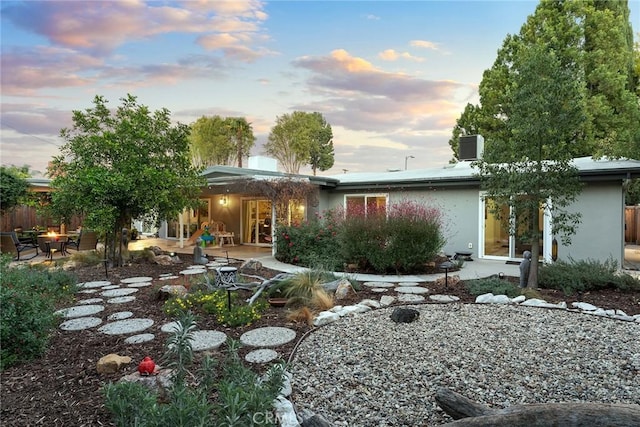 4835 Almidor Ave, Woodland Hills, CA 91364 - back of property at dusk with stucco siding and a patio area
