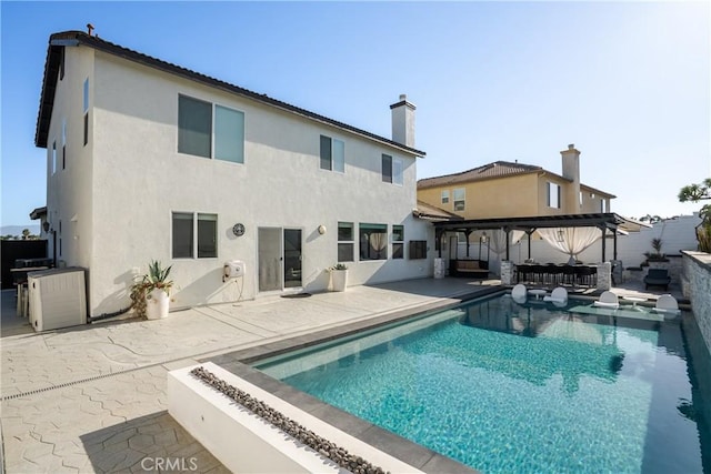 13238 Dancy St, Eastvale, CA 92880 - back of property with a patio area, stucco siding, and a chimney