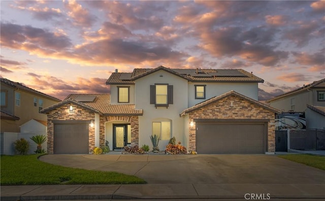 13238 Dancy St, Eastvale, CA 92880 - mediterranean / spanish-style home featuring an attached garage, stucco siding, driveway, and a tile roof
