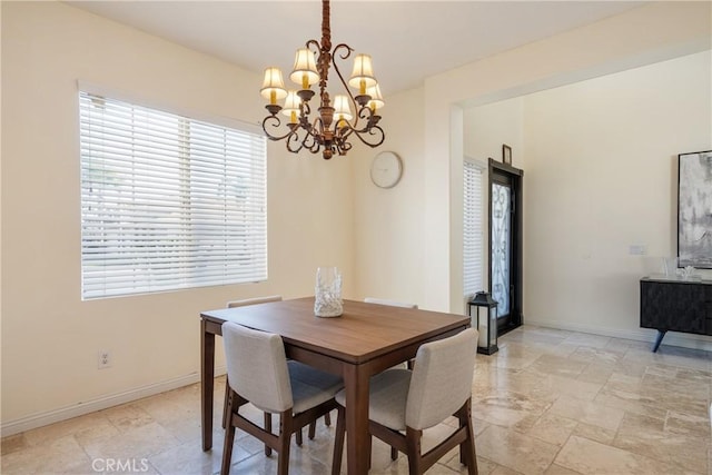 13238 Dancy St, Eastvale, CA 92880 - dining space featuring a chandelier and stone tile flooring