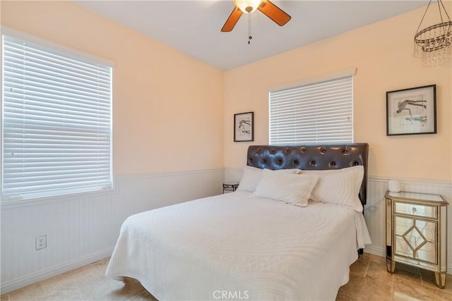 13238 Dancy St, Eastvale, CA 92880 - tiled bedroom with a wainscoted wall and a ceiling fan