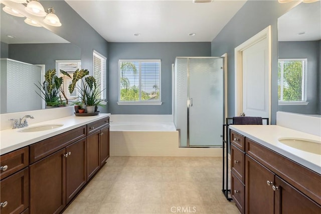 28233 Millstream Ct, Menifee, CA 92585 - bathroom featuring plenty of natural light, a shower stall, two vanities, and a garden tub