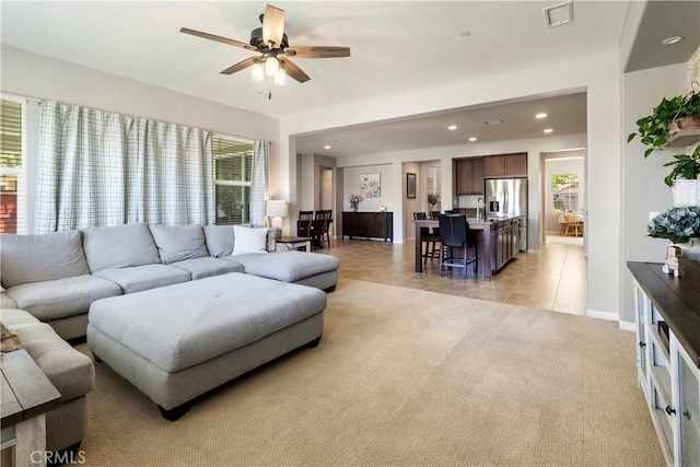 28233 Millstream Ct, Menifee, CA 92585 - living room with recessed lighting, ceiling fan, light tile patterned floors, and light colored carpet