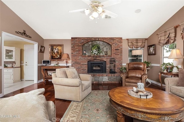 40505 90th St W, Palmdale, CA 93551 - living room with vaulted ceiling, a fireplace, a ceiling fan, and wood finished floors