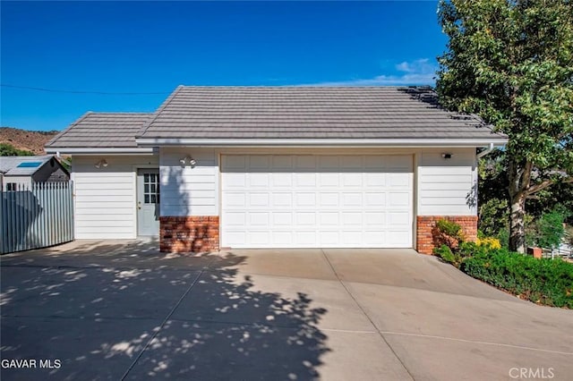 40505 90th St W, Palmdale, CA 93551 - view of front of property featuring brick siding, driveway, and a tile roof