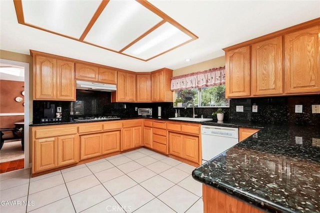 40505 90th St W, Palmdale, CA 93551 - kitchen with white dishwasher, under cabinet range hood, stainless steel gas cooktop, backsplash, and light tile patterned floors