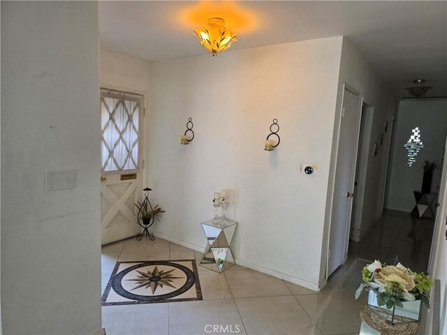 15901 Lassen St, North Hills, CA 91343 - foyer entrance with light tile patterned floors and baseboards