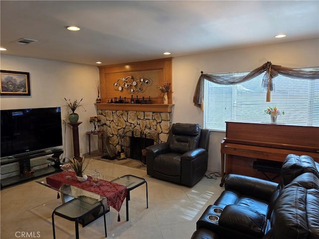 15901 Lassen St, North Hills, CA 91343 - living room featuring recessed lighting, light tile patterned floors, and a stone fireplace