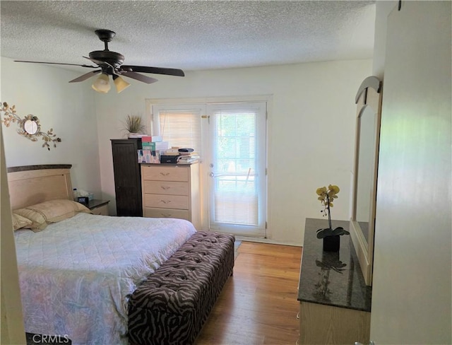 15901 Lassen St, North Hills, CA 91343 - bedroom with light wood finished floors, a textured ceiling, and ceiling fan