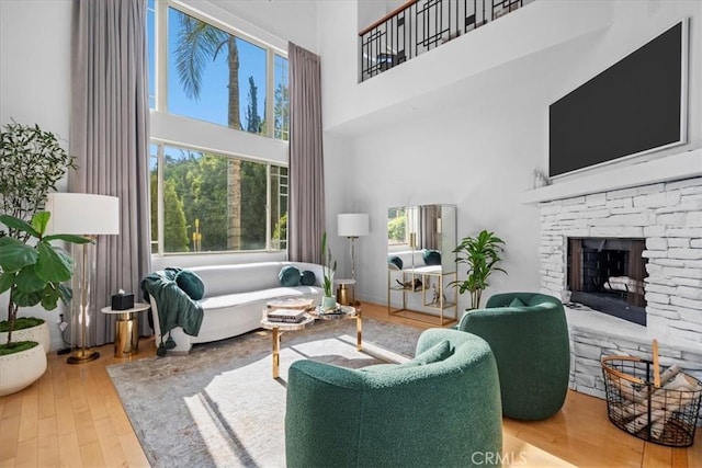 18330 Hanan Ct, Tarzana, CA 91356 - living room featuring a towering ceiling, wood finished floors, and a stone fireplace