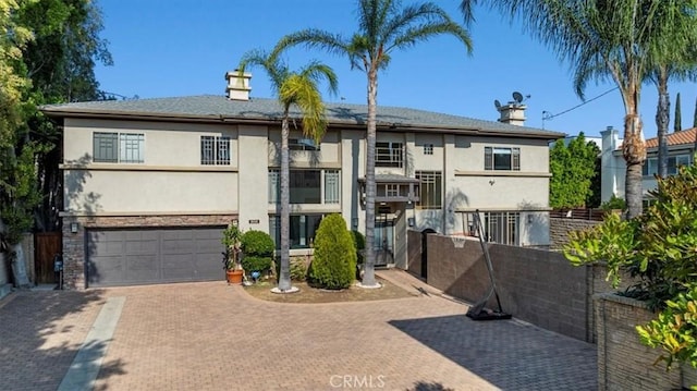 18330 Hanan Ct, Tarzana, CA 91356 - view of front of house featuring stucco siding, decorative driveway, and a garage
