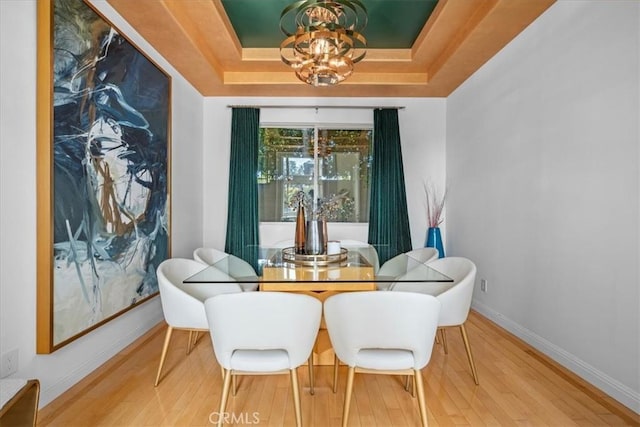 18330 Hanan Ct, Tarzana, CA 91356 - dining area featuring a tray ceiling, wood finished floors, and a chandelier