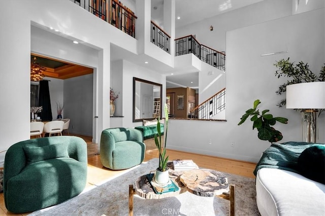 18330 Hanan Ct, Tarzana, CA 91356 - living room featuring wood finished floors, stairway, recessed lighting, and a towering ceiling