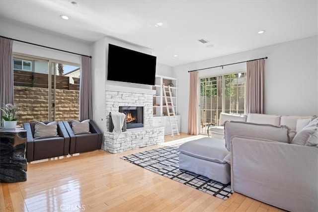 18330 Hanan Ct, Tarzana, CA 91356 - living room featuring wood-type flooring, a stone fireplace, and recessed lighting