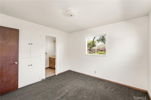 625 S Valley St, Anaheim, CA 92804 - unfurnished bedroom featuring dark colored carpet, a closet, and ensuite bath