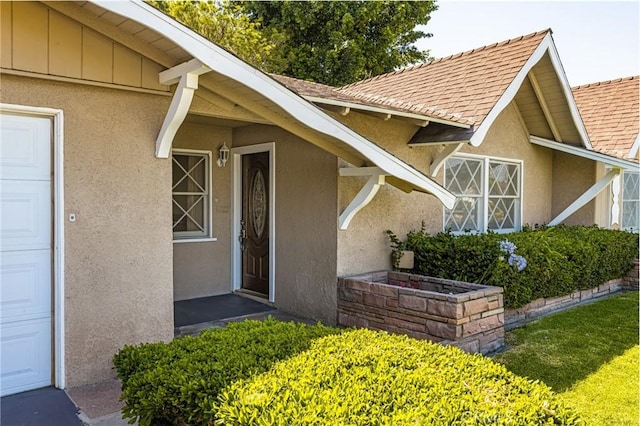 625 S Valley St, Anaheim, CA 92804 - view of exterior entry with stucco siding, roof with shingles, and a garage