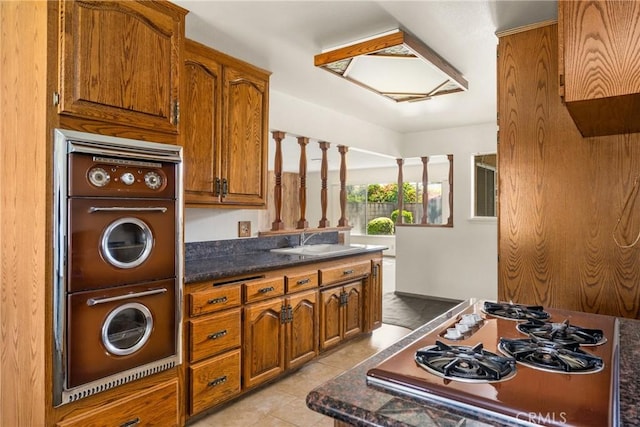 625 S Valley St, Anaheim, CA 92804 - kitchen with gas cooktop, double oven, brown cabinets, and dark countertops