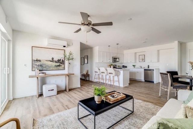 3802 Ranch House Rd Unit 102, San Luis Obispo, CA 93401 - living area with a wall mounted AC, light wood-style flooring, and ceiling fan