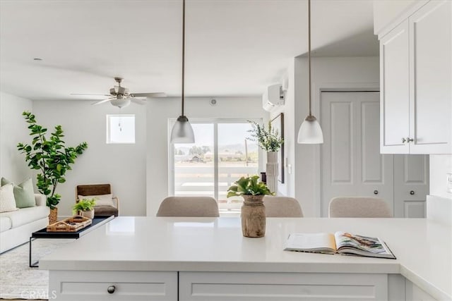 3802 Ranch House Rd Unit 102, San Luis Obispo, CA 93401 - kitchen featuring light countertops, white cabinetry, a ceiling fan, and hanging light fixtures