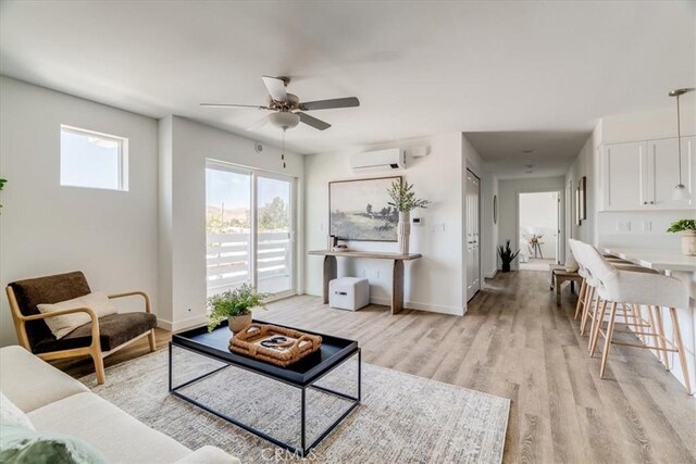 3802 Ranch House Rd Unit 102, San Luis Obispo, CA 93401 - living area with a wall mounted AC, ceiling fan, and light wood-style floors