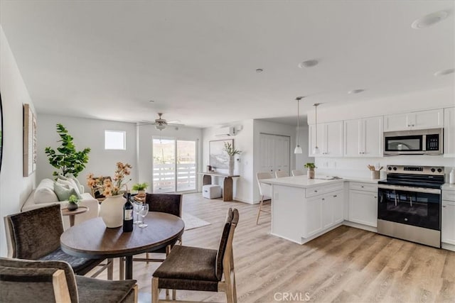 3802 Ranch House Rd Unit 102, San Luis Obispo, CA 93401 - dining space featuring light wood finished floors, a ceiling fan, and an AC wall unit