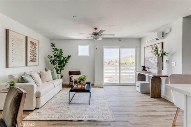 3802 Ranch House Rd Unit 102, San Luis Obispo, CA 93401 - living room featuring a wall mounted air conditioner, ceiling fan, and light wood-type flooring