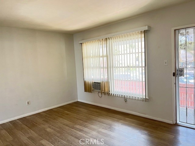122 Elm Ave Unit 9, Long Beach, CA 90802 - unfurnished room with wood finished floors and cooling unit
