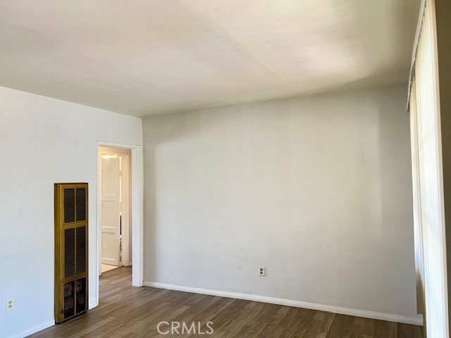 122 Elm Ave Unit 9, Long Beach, CA 90802 - spare room with dark wood finished floors and baseboards