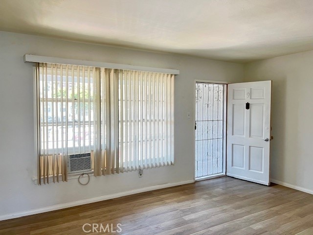 122 Elm Ave Unit 9, Long Beach, CA 90802 - unfurnished bedroom featuring multiple windows and wood finished floors