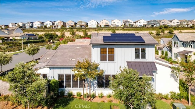 126 Luneta Ln, Rancho Mission Viejo, CA 92694 - back of house featuring a residential view, solar panels, and board and batten siding