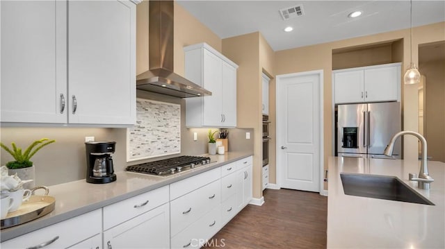 126 Luneta Ln, Rancho Mission Viejo, CA 92694 - kitchen with stainless steel appliances, wall chimney exhaust hood, white cabinetry, tasteful backsplash, and dark wood-type flooring