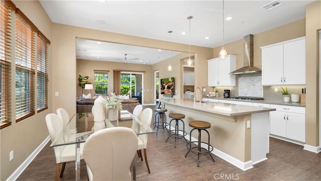 126 Luneta Ln, Rancho Mission Viejo, CA 92694 - kitchen with wall chimney range hood, dark wood finished floors, cooktop, and recessed lighting