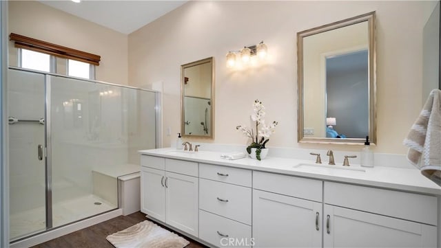 126 Luneta Ln, Rancho Mission Viejo, CA 92694 - ensuite bathroom featuring double vanity, a shower stall, and wood finished floors