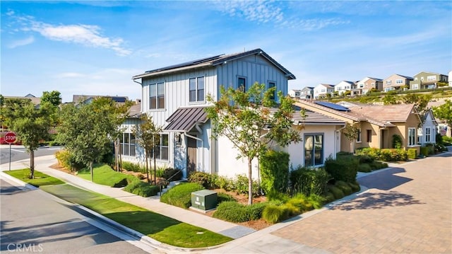 126 Luneta Ln, Rancho Mission Viejo, CA 92694 - view of front facade featuring a residential view, solar panels, and board and batten siding