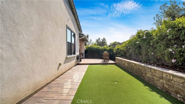 126 Luneta Ln, Rancho Mission Viejo, CA 92694 - view of yard featuring a putting area and a wooden deck