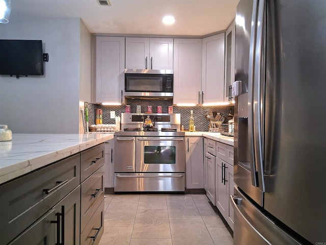 101 Lancer Ave, Oceanside, CA 92058 - kitchen featuring appliances with stainless steel finishes, gray cabinets, tasteful backsplash, light stone countertops, and recessed lighting